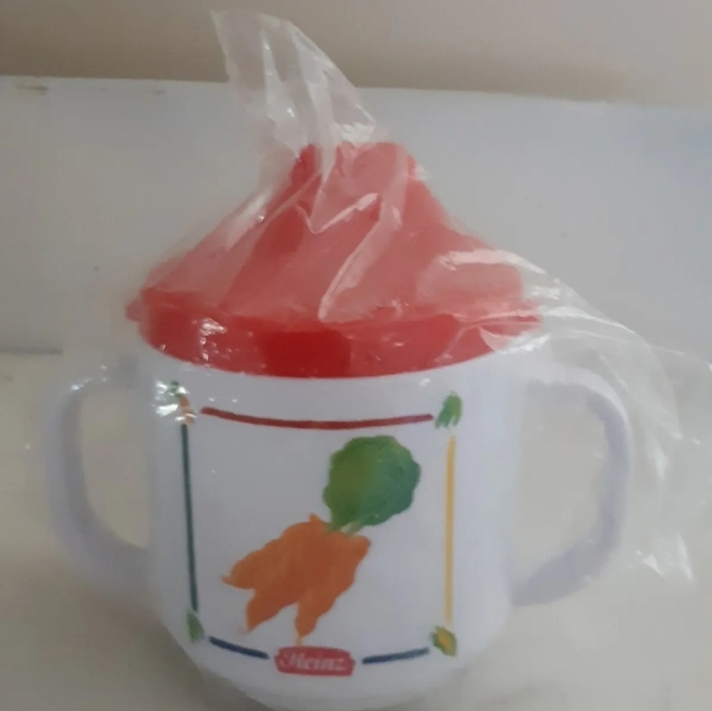Vintage baby Heinz sippy cup with an apple image on one side and carrots on the